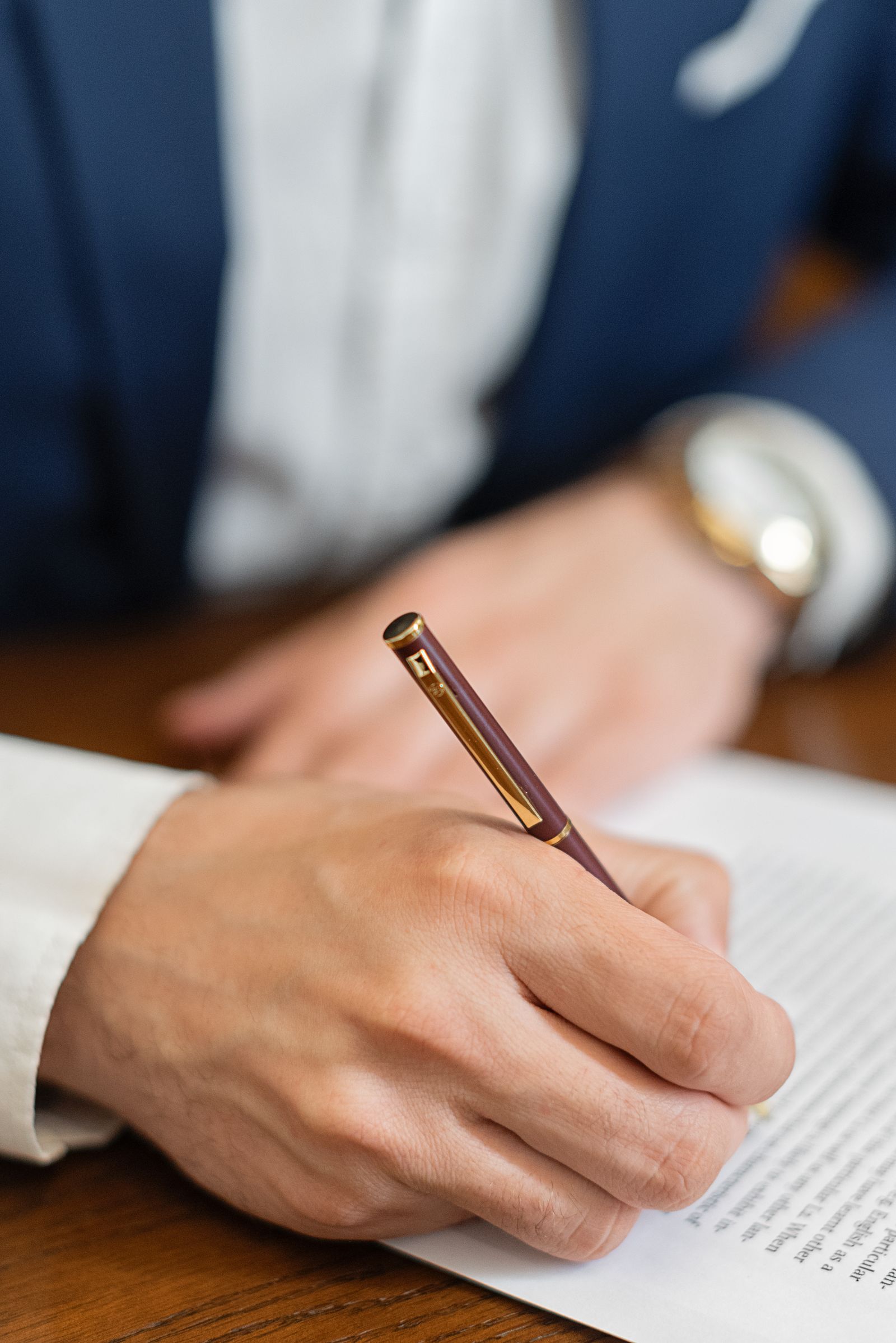 Close-up of a person signing a legal contract